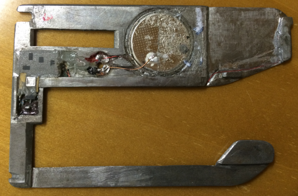 The backside of the insert skimmer reveals a tiny battery and a small data storage device (far left).