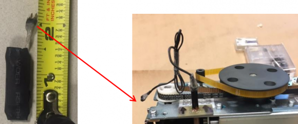 At left, the skimming control device. Pictured right is the skimming control device with wires protruding from the periscope.