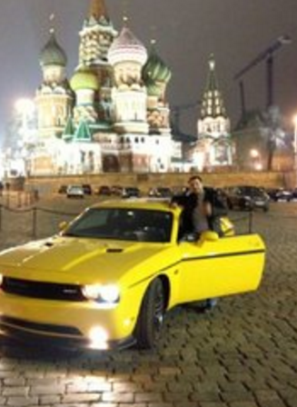 Seleznev posing with a sports car in Red Square. Image: DOJ.