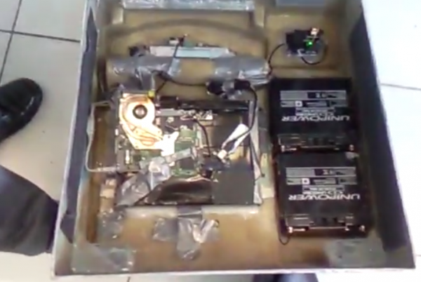 The backside of the fake ATM shows what appears to be laptop and skimmer components powered by two huge batteries.