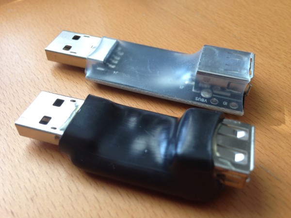 The USB Condom (top) and Juice-Jack Defender, side by side.