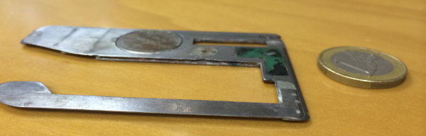 A side view of the stainless steel insert skimmer pulled from a European ATM.