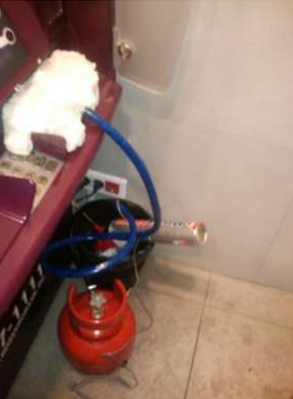 A gas cylinder and pipe found fitted at a compromised ATM before it could be detonated. Source: EAST.