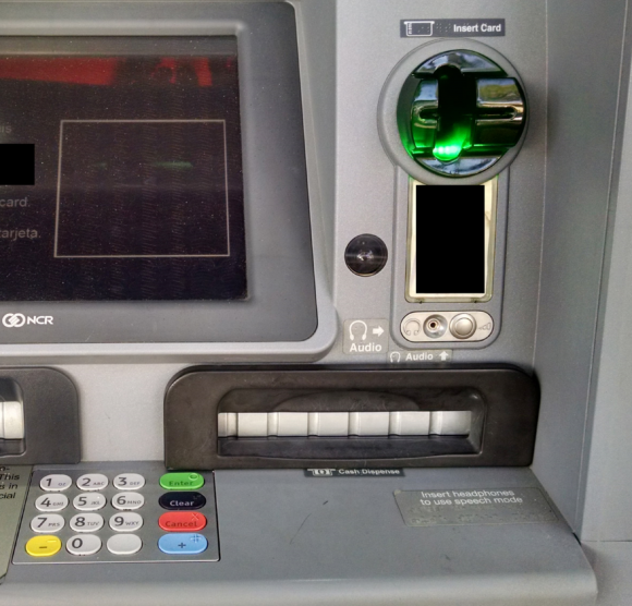 Although it's difficult to tell from even this close, this ATM's card acceptance slot and cash dispenser are both compromised by skimming devices.